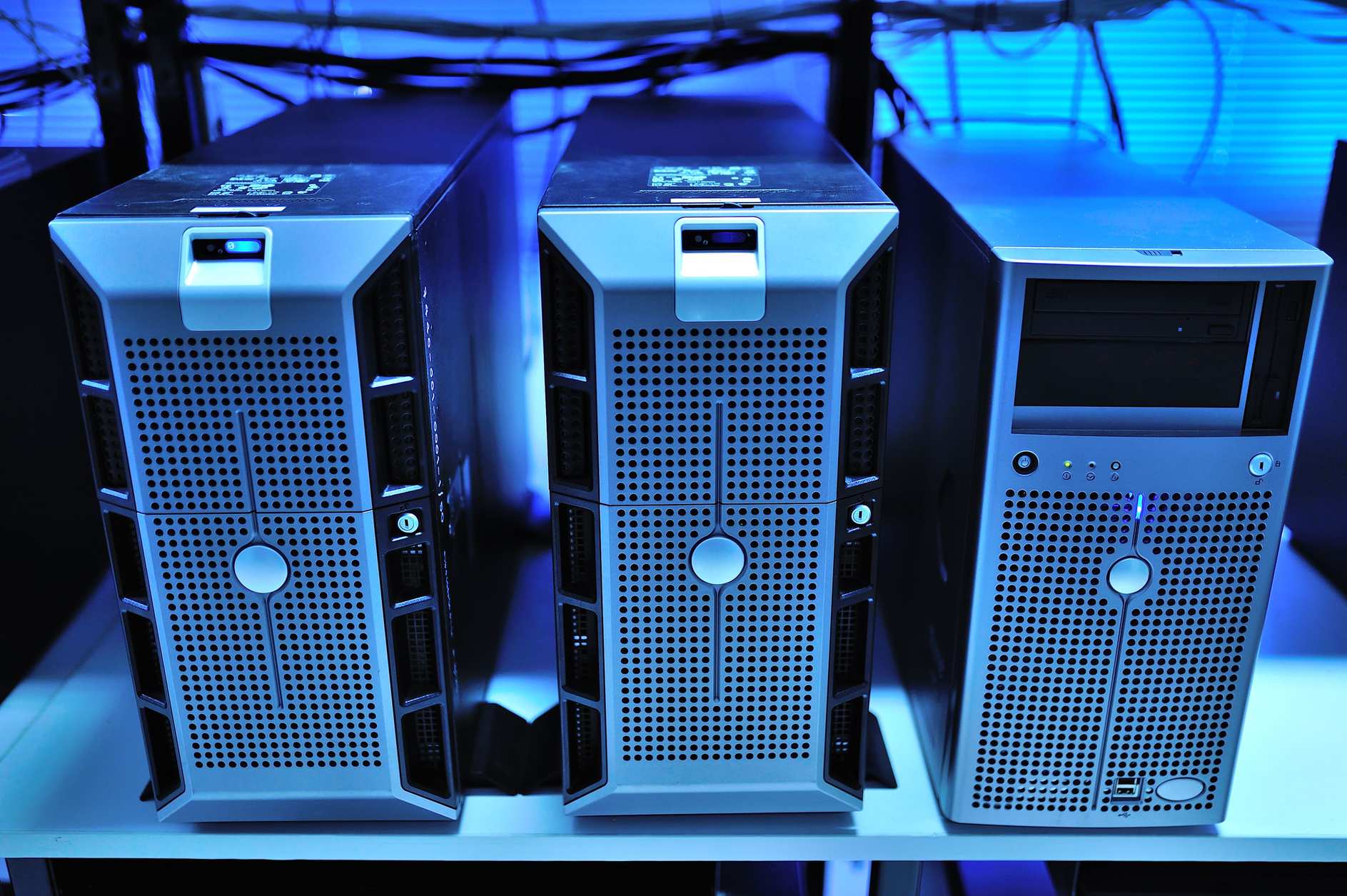 Close view of network switches and cabling in a server rack, with blades in a datacenter